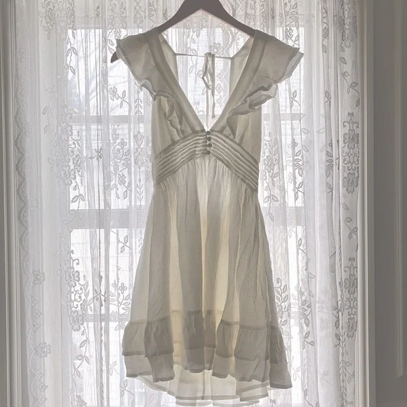 white dress with fringe Bella and Bloom Boutique